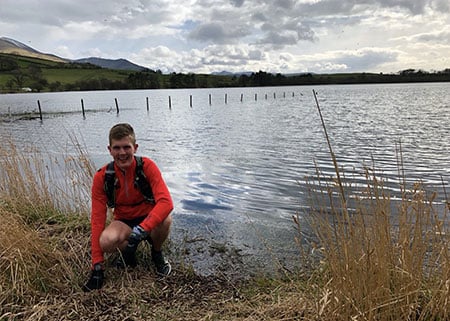 Alex Staniforth in front of a lake