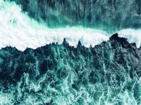 An image of a green/blue wave crashing