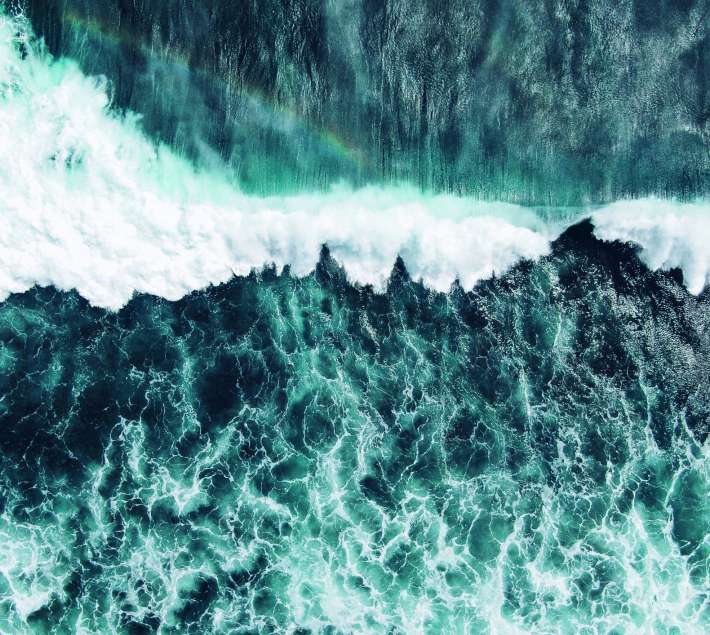 An image of a green/blue wave crashing